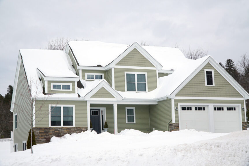 vacant home in winter covered in snow