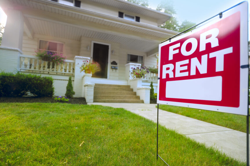 vacant home with for rent sign in lawn